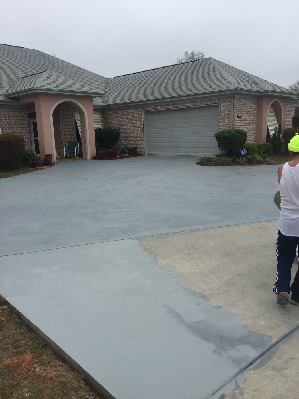 Concrete driveway resurfacing in progress at a home