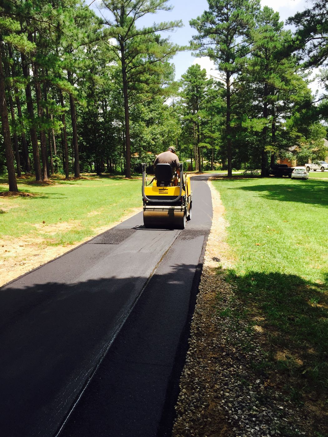 Roller compacting a fresh asphalt driveway